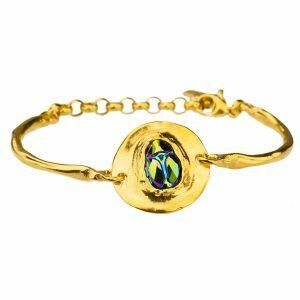 gold bracelet with green crystal