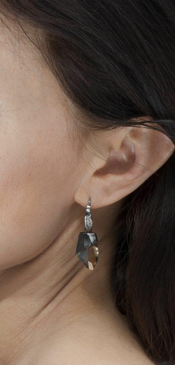 artistic earrings on ear
