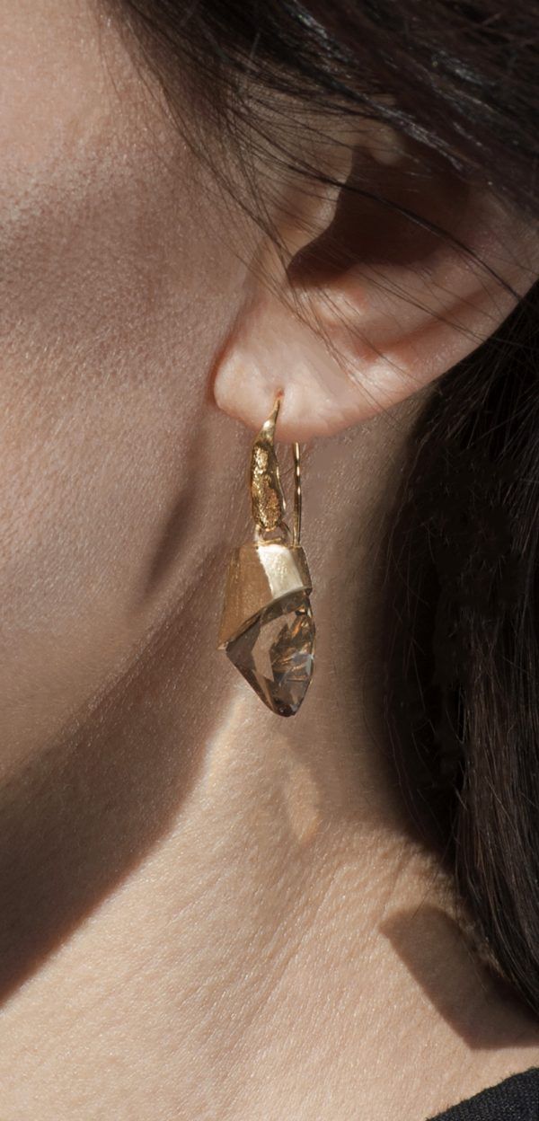 artistic silver earrings on ear